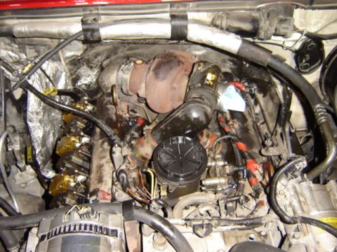 1992 Ford Bronco - Close-up view of an engine bay, highlighting the turbocharger and fuel injection system.
