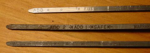 1969 Ford Fairlane - Close-up of three oil dipsticks showing various levels and markings.