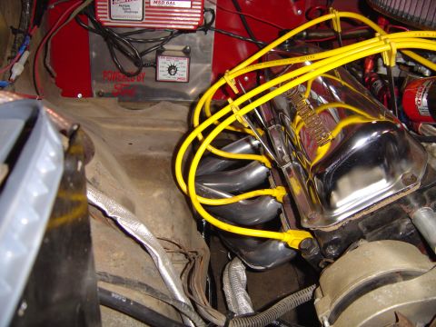 1978 Ford Bronco - Engine bay close-up of a V8 with chrome shorty headers and a chrome valve cover, wired with yellow Taylor plug wires routed through separat…