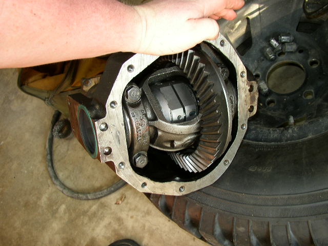 close-up of an open differential gear assembly with a hand holding it