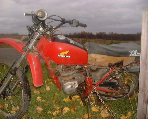 1985 Ford F-150 - This Honda motorcycle has an 'XL' decal on its side panel and appears to be in a state of disrepair.
