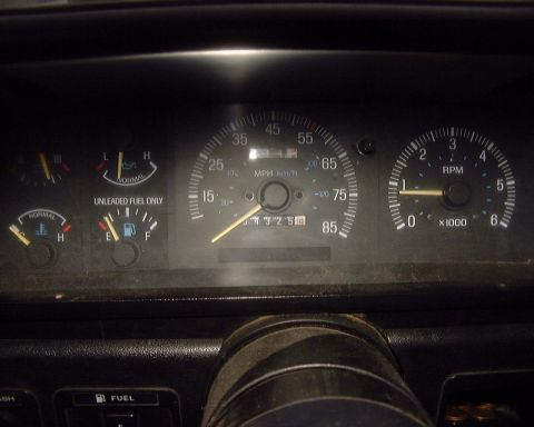 1985 Ford F-150 - Interior view of a vehicle's dashboard gauges, showing speed, RPM, fuel, and temperature readings.