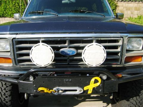 1985 Ford Bronco - Frontal view of a Ford Bronco, likely from the early 1980s, equipped with a winch and auxiliary lights.