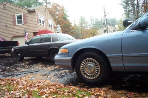 1991 Ford Crown Victoria LTD - Two Ford Crown Victoria LTDs are parked in a driveway during autumn.