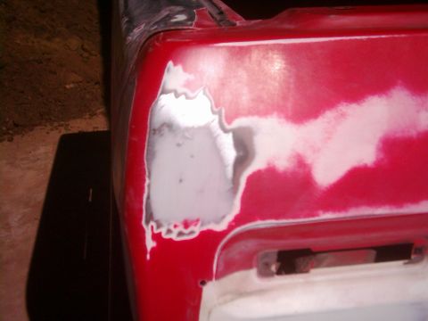 1978 Ford Bronco - Car body panel undergoing repair with Bondo and primer.
