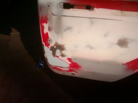 1978 Ford Bronco - A vehicle body panel is shown with red paint, primer, and areas of damage.