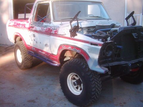 1978 Ford Bronco - This 1978 Ford Bronco is undergoing restoration, showing its off-road tires and partially disassembled front end.
