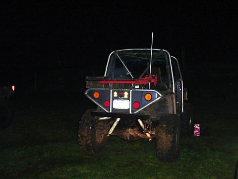 1993 Ford Bronco - This off-road SUV features a custom rear bumper with multiple lights and a prominent roll cage structure.