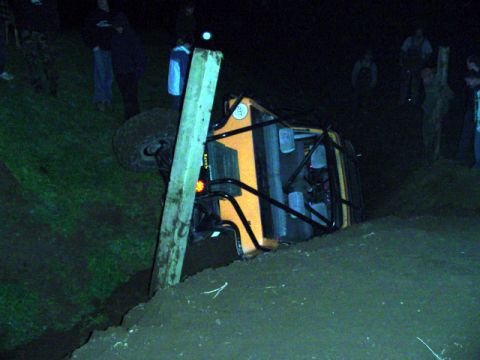 1993 Ford Bronco - An off-road vehicle has tipped onto its side during an event at night.