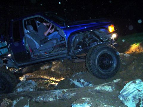 1993 Ford Bronco - Off-road vehicle navigating difficult terrain at night.