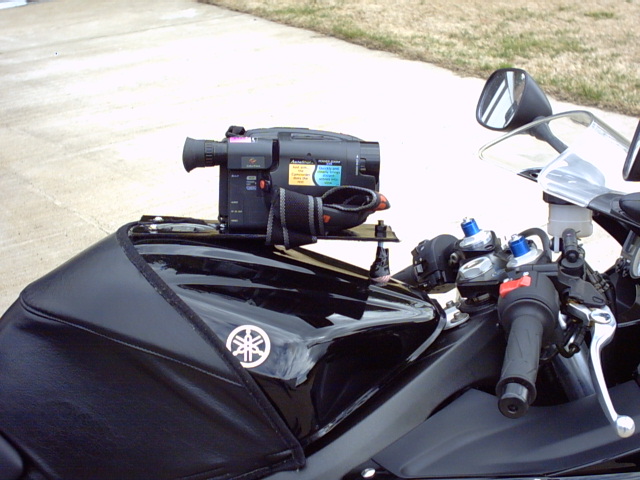Camcorder mounted on a black motorcycle fuel tank with a Yamaha logo