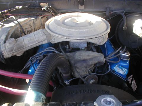 1979 Ford Bronco - Close-up view of a vehicle's engine bay, showing the air intake and carburetor assembly.
