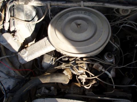 1985 Ford Bronco - Close-up of an engine bay, focusing on the air cleaner and surrounding components.