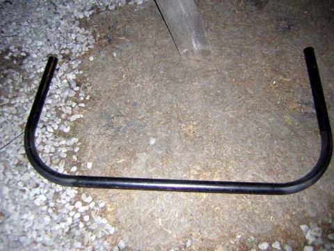 1995 Ford Bronco - This is a bent metal tube, possibly a component for a vehicle or other equipment.