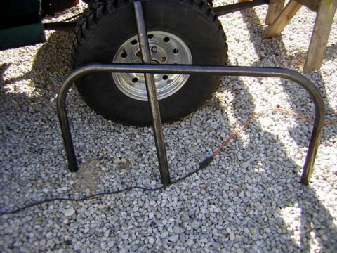 1995 Ford Bronco - A close-up view of a tire and a metal frame on a gravel surface.