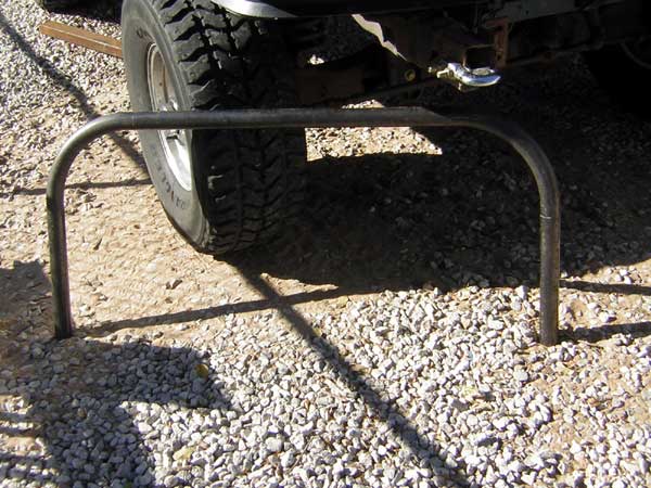 Rear bumper guard on a vehicle with off-road tires