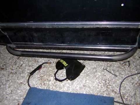 1995 Ford Bronco - Welding equipment and a side step are visible on a gravel surface.