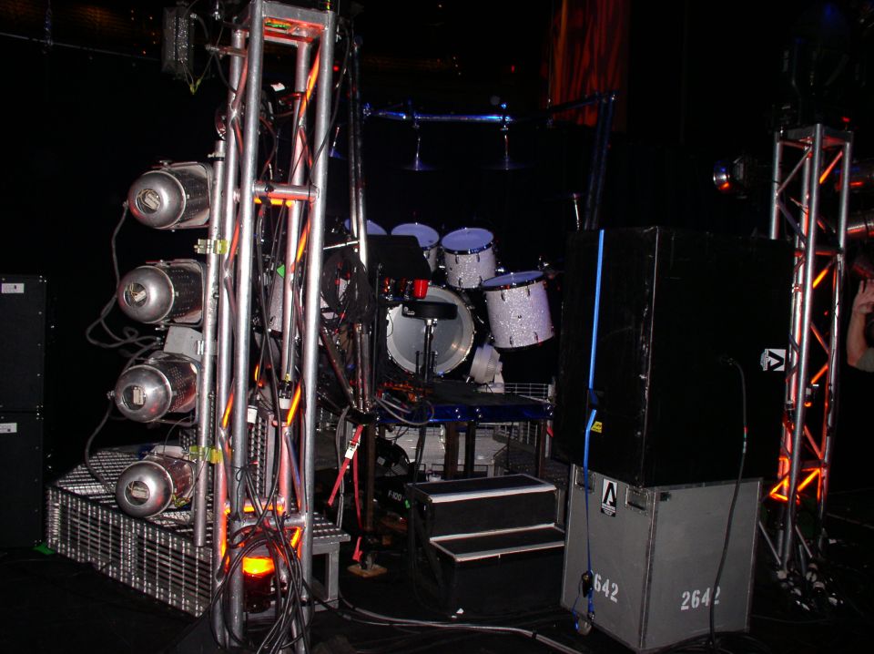 Stage lighting rig with spotlights and a drum kit