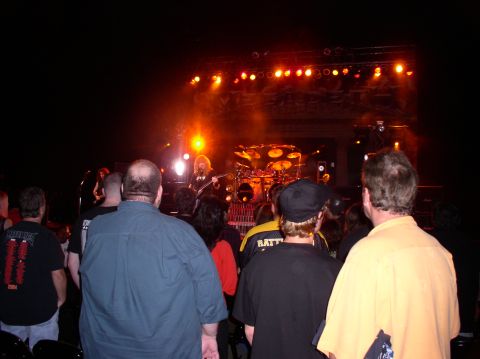 1990 Ford Bronco - A band plays on a brightly lit stage as a crowd watches from the darkness.