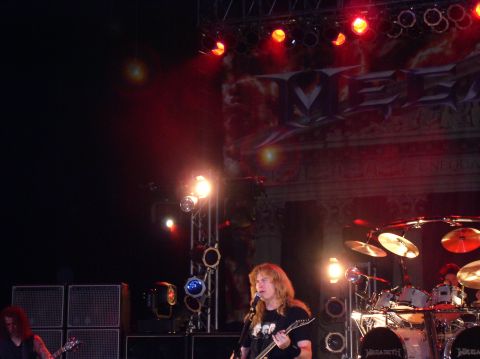 1990 Ford Bronco - A band performs live on a stage with bright lights and a large backdrop.