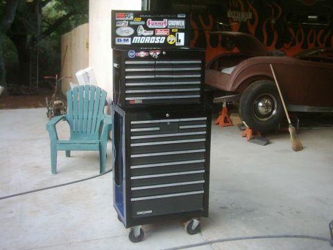 1978 Ford Bronco - A toolbox sits in front of a car body undergoing repairs in a garage.