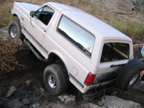 1985 Ford Bronco - This 1985 Ford Bronco navigates a challenging rocky terrain, its off-road capabilities.