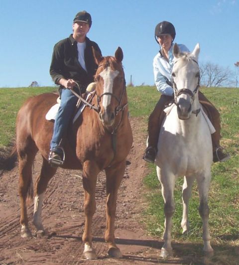 1994 Ford Bronco - Two individuals enjoy a horseback ride on a sunny day.