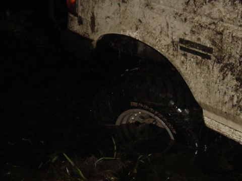 1989 Ford Bronco - A close-up view of a muddy tire and fender, suggesting off-road use.