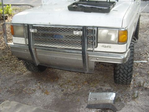 1989 Ford Bronco - Front view of a white Ford truck, possibly from the late 1980s, with a substantial brush guard and aftermarket grille.