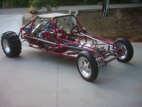 1978 Ford Bronco - This custom dune buggy features a tubular frame, dual seats, and a roll cage, with sand tires on the rear and polished wheels on the front.