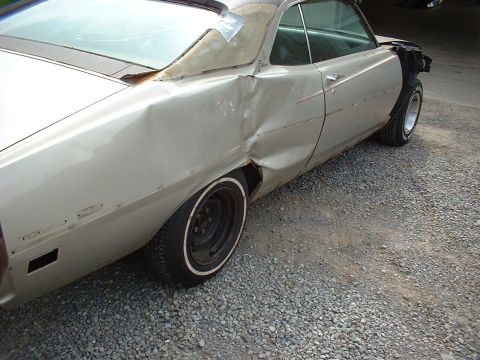 1971 Ford Torino - This silver car has significant body damage to the rear quarter panel and door, with a missing front fender and peeling vinyl top.