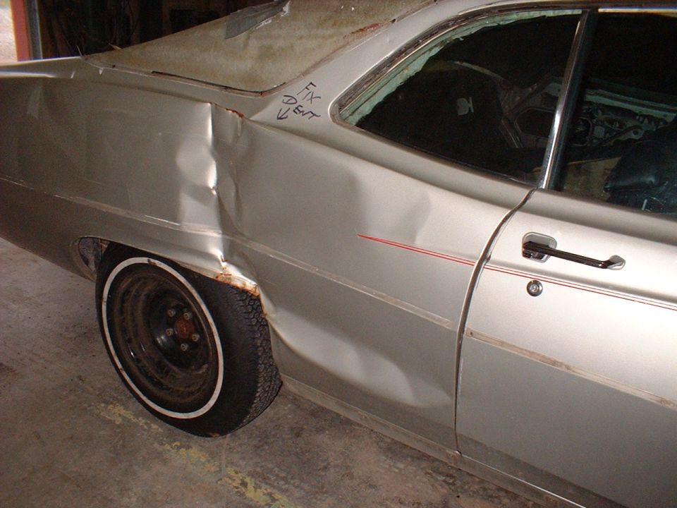 1971 Ford Torino with significant rear quarter panel damage and rust