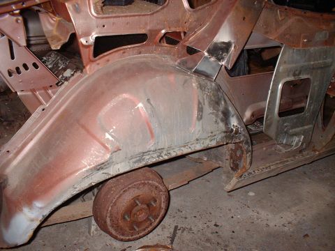 1971 Ford Torino - This is a close-up view of a heavily rusted car body, showing the wheel well and a drum brake.