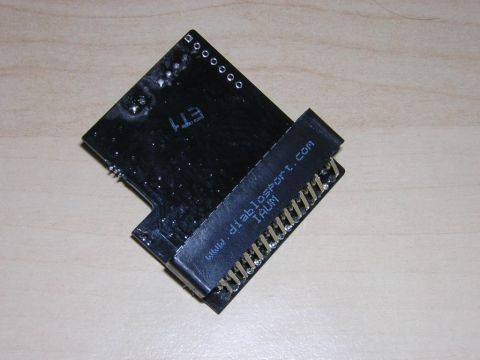 1998 Ford Crown Victoria - underside of a black tuning module board with a card-edge connector, marked with the text www.diablosport.com.