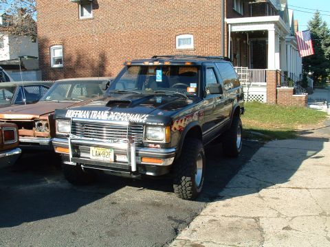 1994 Ford Bronco - This modified SUV, likely from the early 1990s, does not match the 1994 Ford Bronco claim.