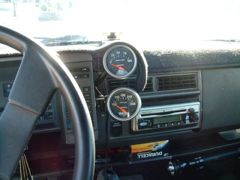 1994 Ford Bronco - Aftermarket oil and water temperature gauges are visible on the dashboard of this vehicle.