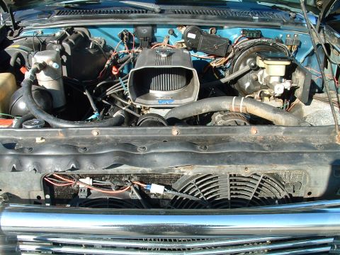 1994 Ford Bronco - Close-up view of a vehicle's engine bay, showing various components and wiring.