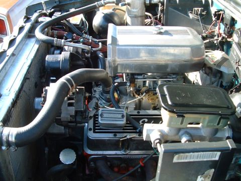 1994 Ford Bronco - Close-up view of a V8 engine bay, a chrome air cleaner and brake fluid reservoir. The registry claims this is a 1994 Ford Bronco, but the e…