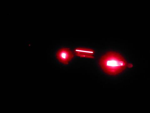 1996 Mercury Sable - A close-up view of a vehicle's illuminated taillight assembly at night.