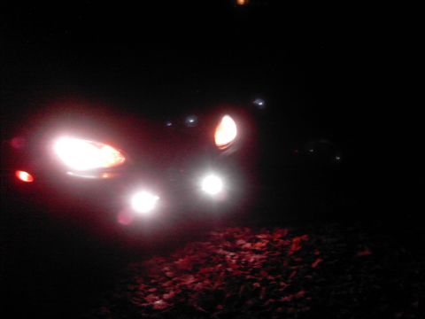 1996 Mercury Sable - The front of a car is visible at night, illuminated by its headlights.