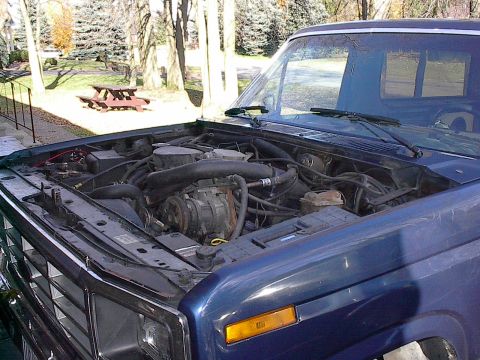 1986 Ford Bronco - Hood off, cleaning hinges for paint with hood. Good time to remove or tweak cowl panel if you need to.