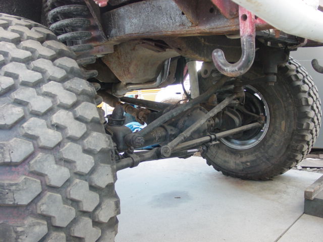 Close-up of off-road vehicle suspension components and large tires