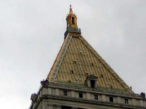 1995 Ford Bronco - The ornate rooftop of a building features a golden, sloped roof and a decorative spire against a cloudy sky.