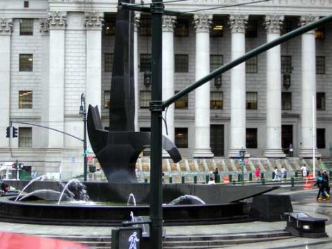 1995 Ford Bronco - A striking black abstract sculpture dominates the foreground of this scene, set against the backdrop of a grand building with classical col…
