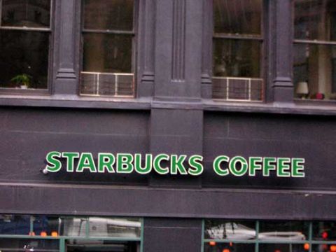 1995 Ford Bronco - A prominent Starbucks Coffee sign is visible on the exterior of a building.