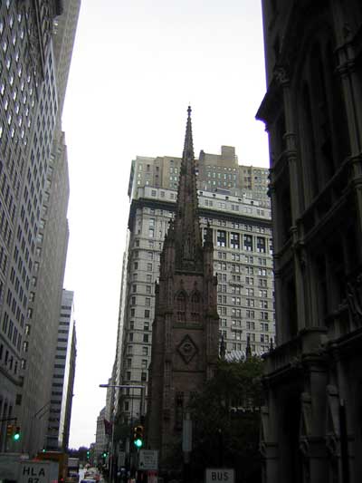 1995 Ford Bronco - A view of Trinity Church in New York City, framed by tall office buildings on a cloudy day.