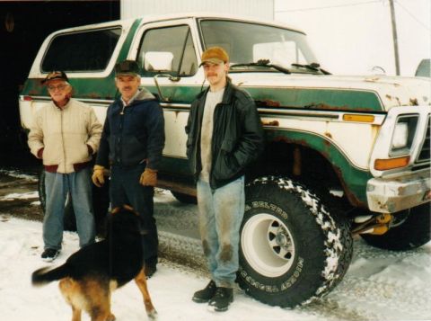 1978 Ford Bronco - A group poses with a classic Ford Bronco, showing off its exterior in a snowy setting.