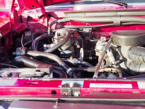 1994 Ford C-150 (Centurion Conversions) - Close-up view of a vehicle's engine bay, showing various mechanical parts and wiring.