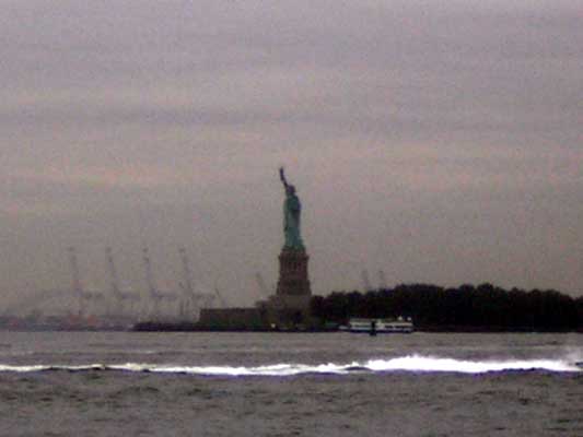 Statue of Liberty with ferry and cranes