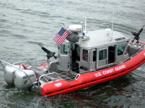 1995 Ford Bronco - A U.S. Coast Guard boat with mounted weaponry navigates through the water.